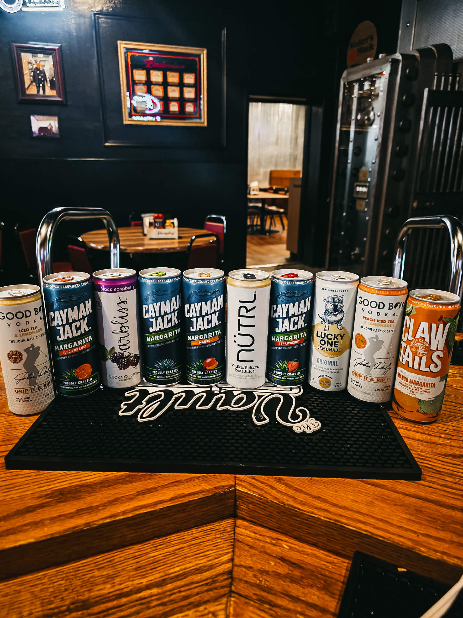 Canned cocktail selection at The Vault — Good Boy Vodka, Cayman Jack, Carbliss, Lucky One, Claw Tails