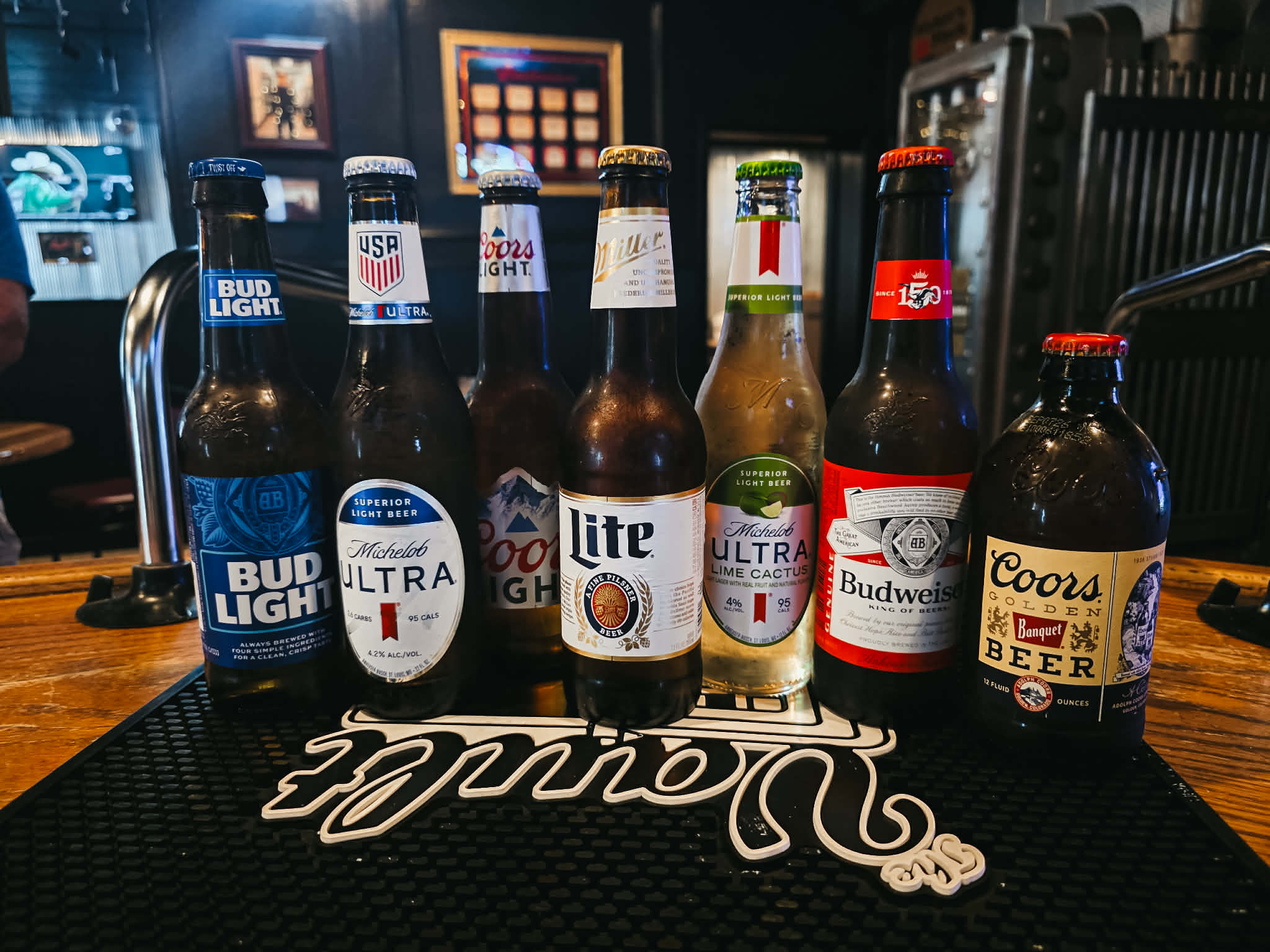 Domestic beer bottles at The Vault — Bud Light, Michelob Ultra, Coors Light, Miller Lite